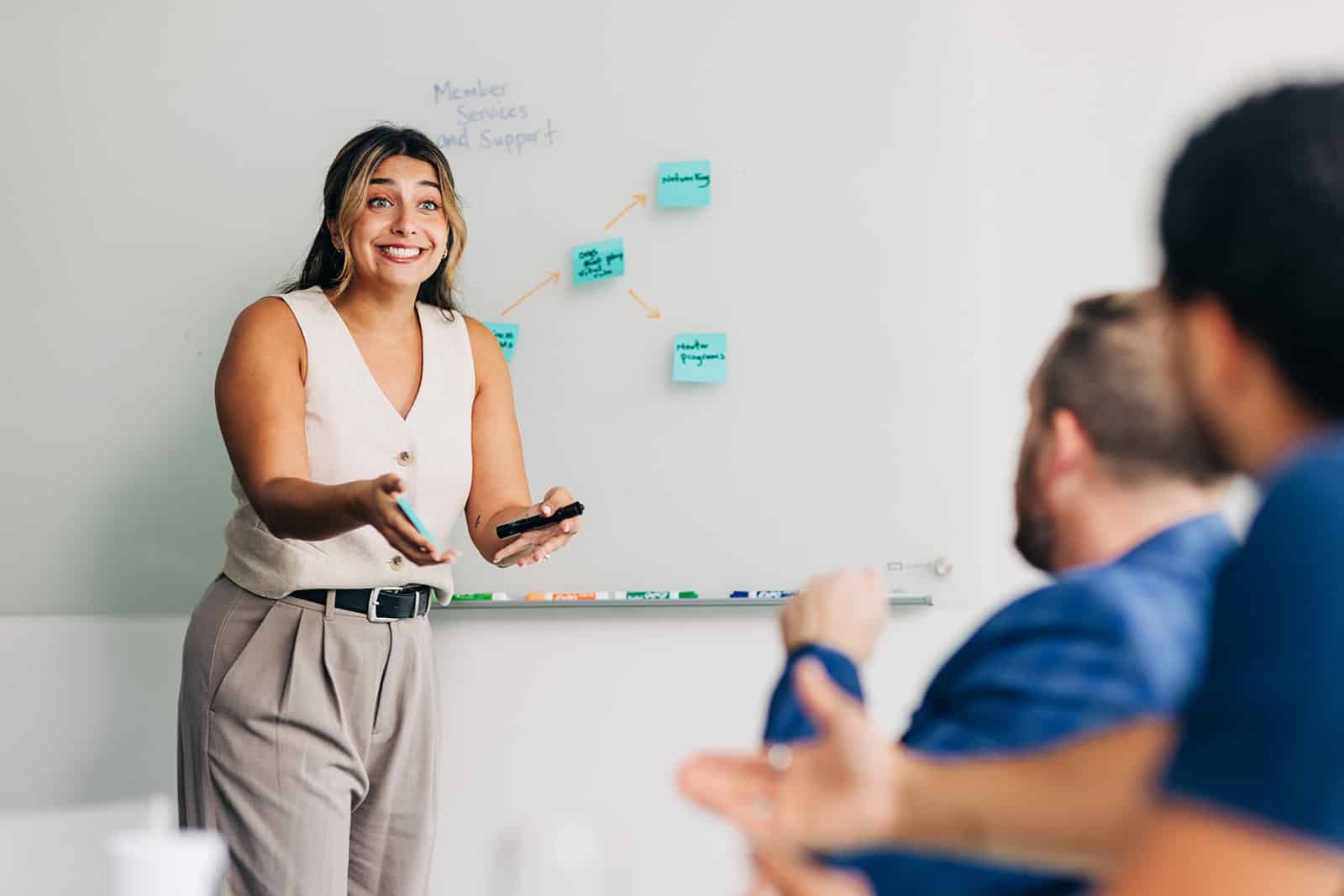 Person presenting in a meeting room.